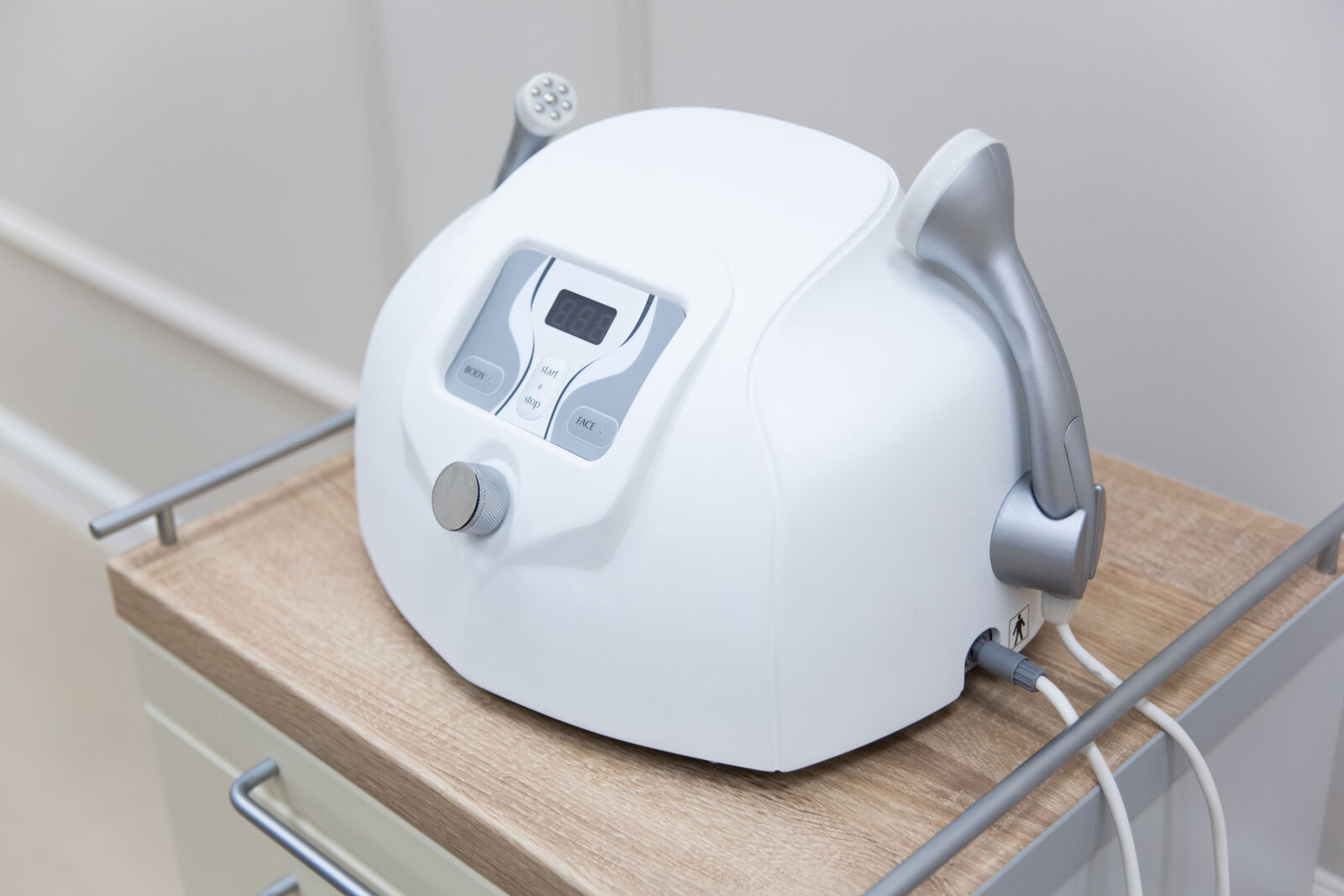Body and face radiofrequency unit with handpiece in a wellness treatment room
